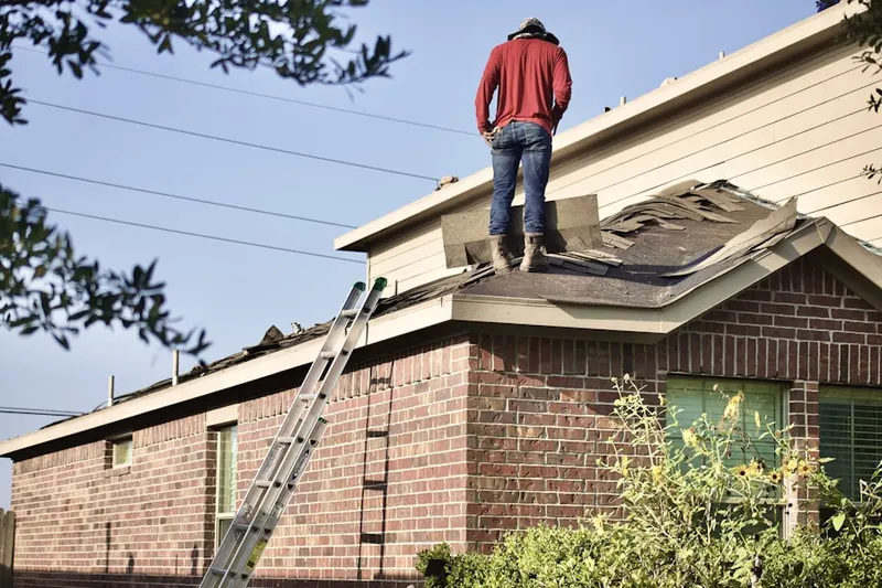 Professional roofer working on a residential roof in Rose Ranch